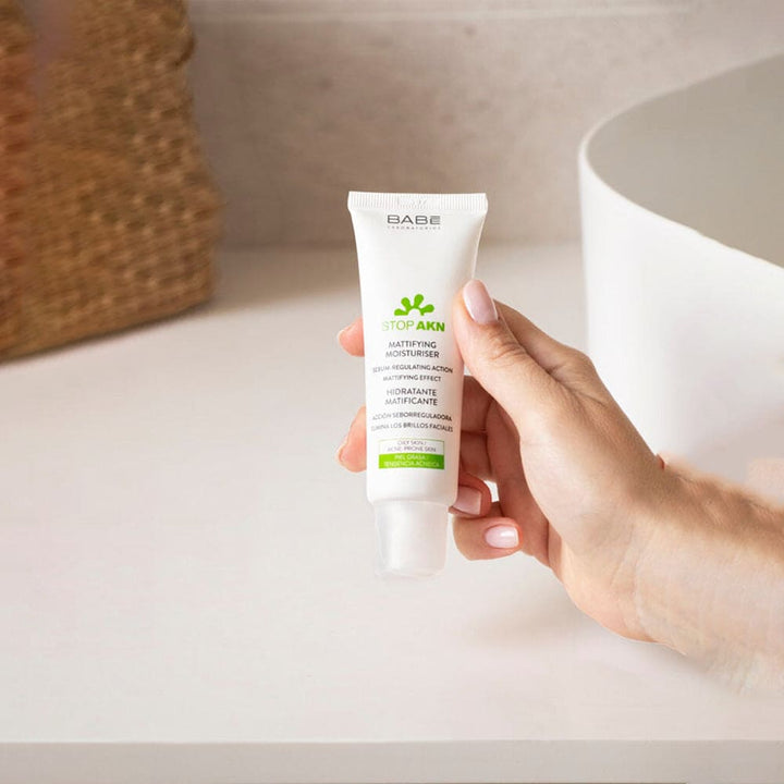 Image: Babé Purifying Cleansing Gel - A transparent bottle with vibrant green leaves, evoking freshness and the power of natural ingredients for clear, radiant skin.