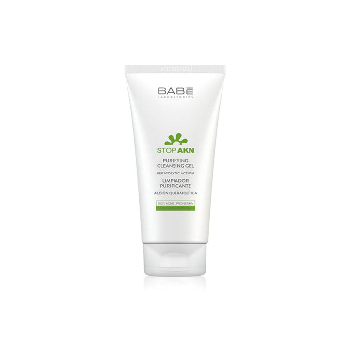Image: A clean, clear bottle of Babé Purifying Cleansing Gel, surrounded by fresh green leaves, symbolizing purity and natural ingredients.