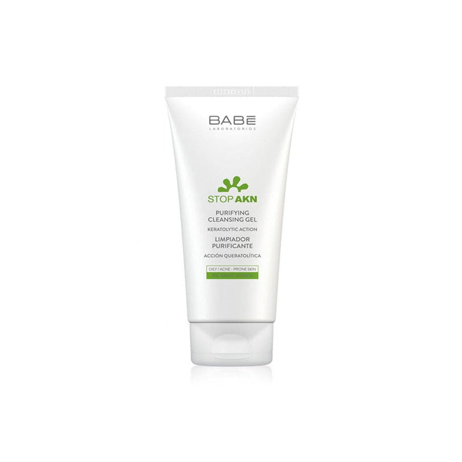 Image: A clean, clear bottle of Babé Purifying Cleansing Gel, surrounded by fresh green leaves, symbolizing purity and natural ingredients.